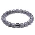 Detailed view of 8mm gray stone beads and a black cylindrical metal bead on a men's bracelet - Map Stone Bracelet
