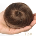 Synthetic drawstring hair bun extension in brown shade 12# shown held by hand - 12# (Light Brown)