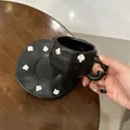 Handmade matte black ceramic coffee cup and saucer set with white spade embossed patterns - Spades Clubs