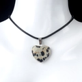Beige spotted natural stone heart pendant necklace with black cord on model - Dalmatian Jasper