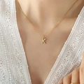Elegant gold titanium necklace with sparkling zircon Letter K pendant on a model - Letter K / Gold