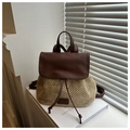 Detail of hand-woven straw texture and dark brown leather flap on summer backpack - Brown