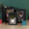 Three sizes of premium black paper gift bags with clear PVC windows and ribbon handles - Black