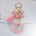 Pink resin letter O keychain with glitter butterfly pendant and leather tassel - Letter O