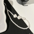 Detail view of pearl phone strap featuring white heart beads on a minimalist background - Pearly Heart Lanyard