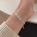 Detailed close-up of a silver bracelet featuring three hollow five-petal flower motifs - Silver Three Hollow Flowers (MY35257)