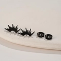 Detailed view of black fan-shaped stainless steel stud earrings with sunburst design - Black