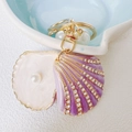 Llavero de concha brillante con diamantes de imitación morados, perlas y clip dorado - Llavero Estándar / Morado