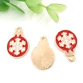 Christmas charms featuring red enamel snowflake patterns with a golden metal finish - Round Christmas Snowflake 13x19mm