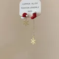 Asymmetric Christmas earrings featuring a Santa hat, stocking, and gold snowflakes - Asymmetric Christmas Earrings