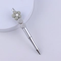 Close-up of silver DIY beaded pen with grey silicone flower and geometric bead accents - Gray