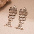Detail view of silver fishbone earrings featuring unique swirling embossed metal texture - Silver (Silver Pin) / Silver
