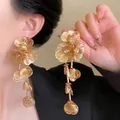 Elegant gold flower tassel earrings with layered petals and sparkling rhinestones - Brushed Floral Tassel Style (HE14036) / Gold