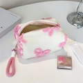 White plush cosmetic bag with pink flower patterns and a fuzzy carrying handle - Handheld White With Bow Print