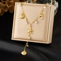 Detail of gold Y-shaped necklace with sea shells and pearls on a display box - Marine Life Pendant Style (N3521)