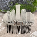 Close-up of clear crystal comb with black metal wire, pentagram, and moon charms - White Crystal Black Wire Silver Moon