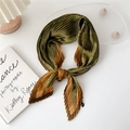 Olive green pleated silk scarf with brown geometric patterns tied in a neat knot - Small Arrow Plaid Green