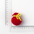Handmade red crochet drawstring bag keychain accessory shown with a clear measuring ruler - Red Knitted Money Bag