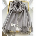 Classic grey cashmere scarf with elegant tassels and minimalist brand label on gold frame - Gray