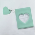 Detail of mint green mini photo album with heart-shaped cutout and matching charm - Jelly Mint