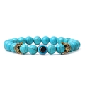 Macro view of blue turquoise beads with evil eye charm and golden crown accents - Synthetic Turquoise (01)