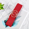 Detail of red elastic waist belt with double gold rings buckle on marble background - Red