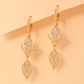 Macro shot of gold-plated drop earrings featuring zircon-studded butterfly and leaf charms - EH092 Disc Butterfly Leaf Style