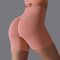 Seamless peach pink high waisted yoga shorts with ruched butt lifting detail for fitness - Tropical Orange