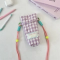 Close-up of quilted purple checkered camera bag with heart stitching and colorful straps - Purple Checkered