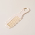 Creamy white baby comb with fine rounded teeth and ergonomic hanging hole handle - White Comb