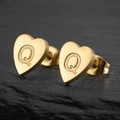 Golden stainless steel heart stud earring featuring engraved letter Q on a stone surface - Letter Q / Gold