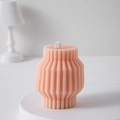 Pink geometric pillar scented candle with elegant vertical pleats on a white pedestal - Soft Pink