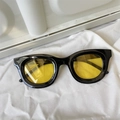 Detail of trendy black oversized frame sunglasses with vibrant yellow lenses and metal hinges - Thick Black Frame Yellow Lens