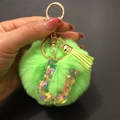 Detail of green fur pompom keychain with heart sequin resin letter U and gold clip - Letter U