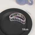 Macro detail of 10cm holographic laser hair claw clip on a grey ceramic tray - 5# Hollow Round-10cm