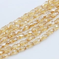 Macro shot of multi-strand champagne faceted fish-shaped glass beads for jewelry making - 6*10mm (approximately 50 Beads) / Amber Gold