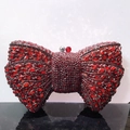 Close-up of red rhinestone bow evening clutch bag with sparkling crystal details - Red / Gunmetal Hardware