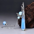 Macro detail of opalite hexagonal crystal pendant with silver angel wing charm - Silver Opalite
