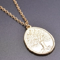 Detailed close-up of golden oval pendant featuring a Tree of Life design on O-chain necklace - Gold Color Pendant And Chain