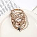 Close-up of four high-elastic hair ties with flower and crown charms in coffee tones - 4Pcs Set - Pineapple Style / Light Coffee