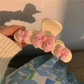 Detail of a creamy white hair claw clip with three pink bows under warm evening sunlight - Pink Bow Decor / White Pink Flower Hair Claw