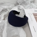 Close-up of a wide navy blue pleated headband on decorative white paper and magazine - Navy Blue