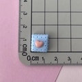Macro shot of 1.5cm blue resin heart cookie charm with ruler for size reference - Blue Heart Biscuit