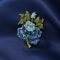 Macro detail of vintage blue rhinestone rose brooch on a luxurious silk background - Blue