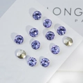 Macro detail of faceted lavender K9 crystals and gold rhinestones on display board - Gem 8mm