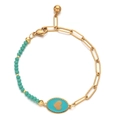Macro view of gold paperclip chain and turquoise beads bracelet with heart enamel charm - Lake Blue
