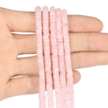 Hand holding five strands of pink translucent square spacer beads for DIY jewelry making - 150 Pieces / Rose Quartz