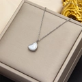 Elegant silver heart necklace with white mother-of-pearl inlay on a jewelry box - Small Silver White Shell Heart