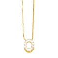 Macro detail of gold letter O pendant necklace with sparkling zircon channel setting - Gold O