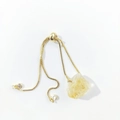 Detailed view of adjustable golden box chain with raw yellow crystal quartz stone - Citrine